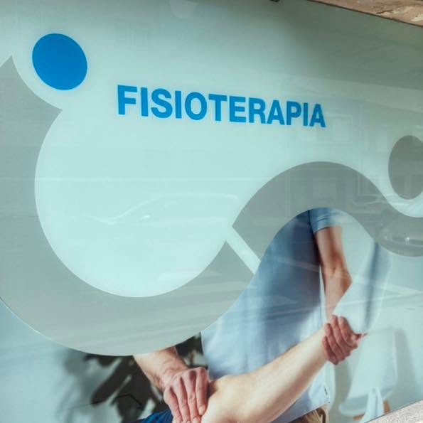 Montra da clínica com a palavra Fisioterapia e imagem de um exercício de reabilitação do braço.